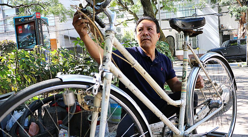 En la banca de un parque, Vicente saca adelante su taller de bicicletas después del 19S